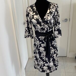 Floral black and cream wrapped dress in silky polyester and spandex blend size 9
